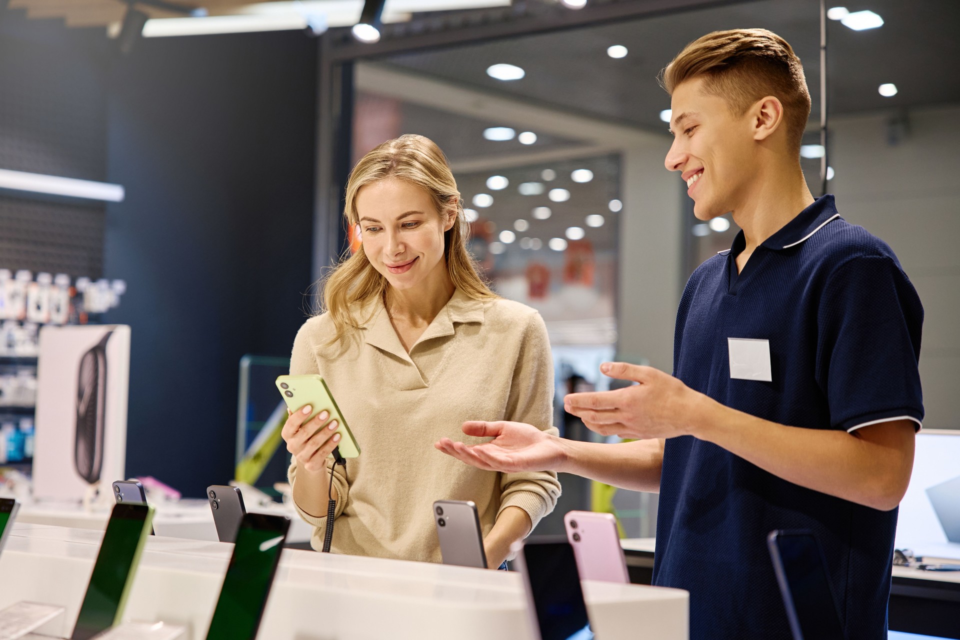 Customer and Salesperson Actively Engaged in the Smartphone Selection Process at Retail Store